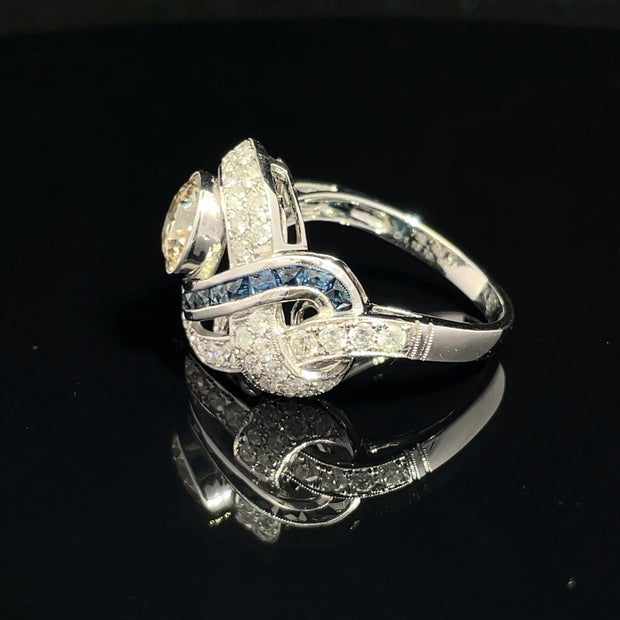 18K White Gold swirling Blue Sapphire and Natural Diamond Ring
